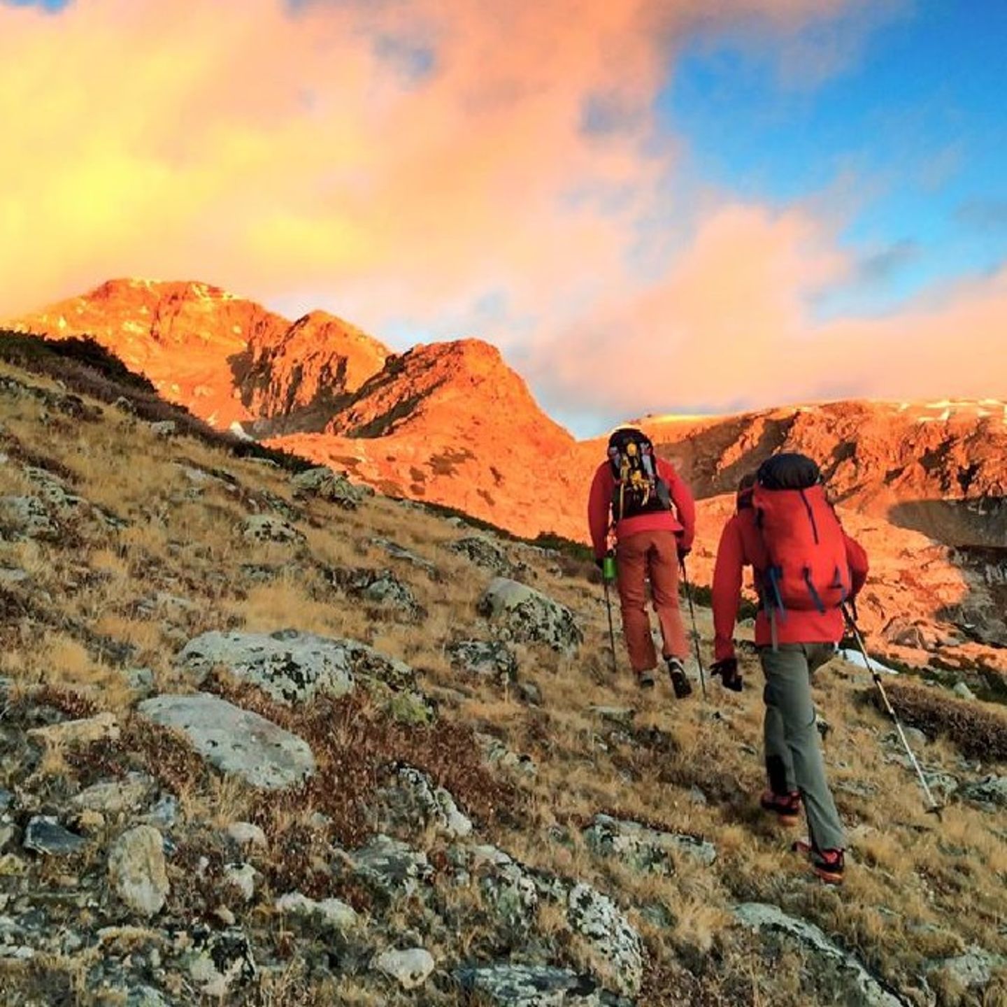 Two people hiking up mountain