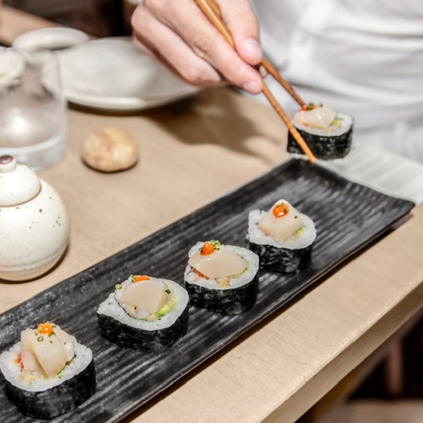 Person eating sushi rolls