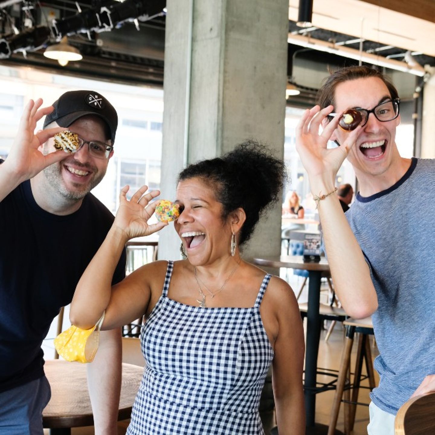 Group Posing with Donut Holes on Eye