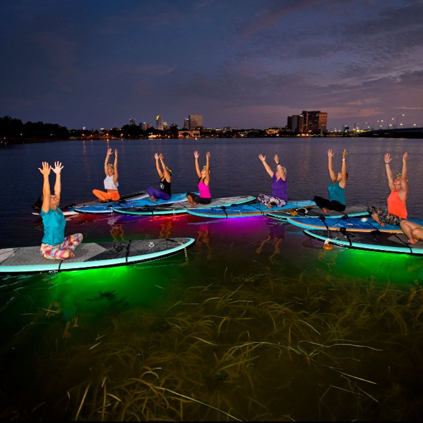 Group on light up paddleboards
