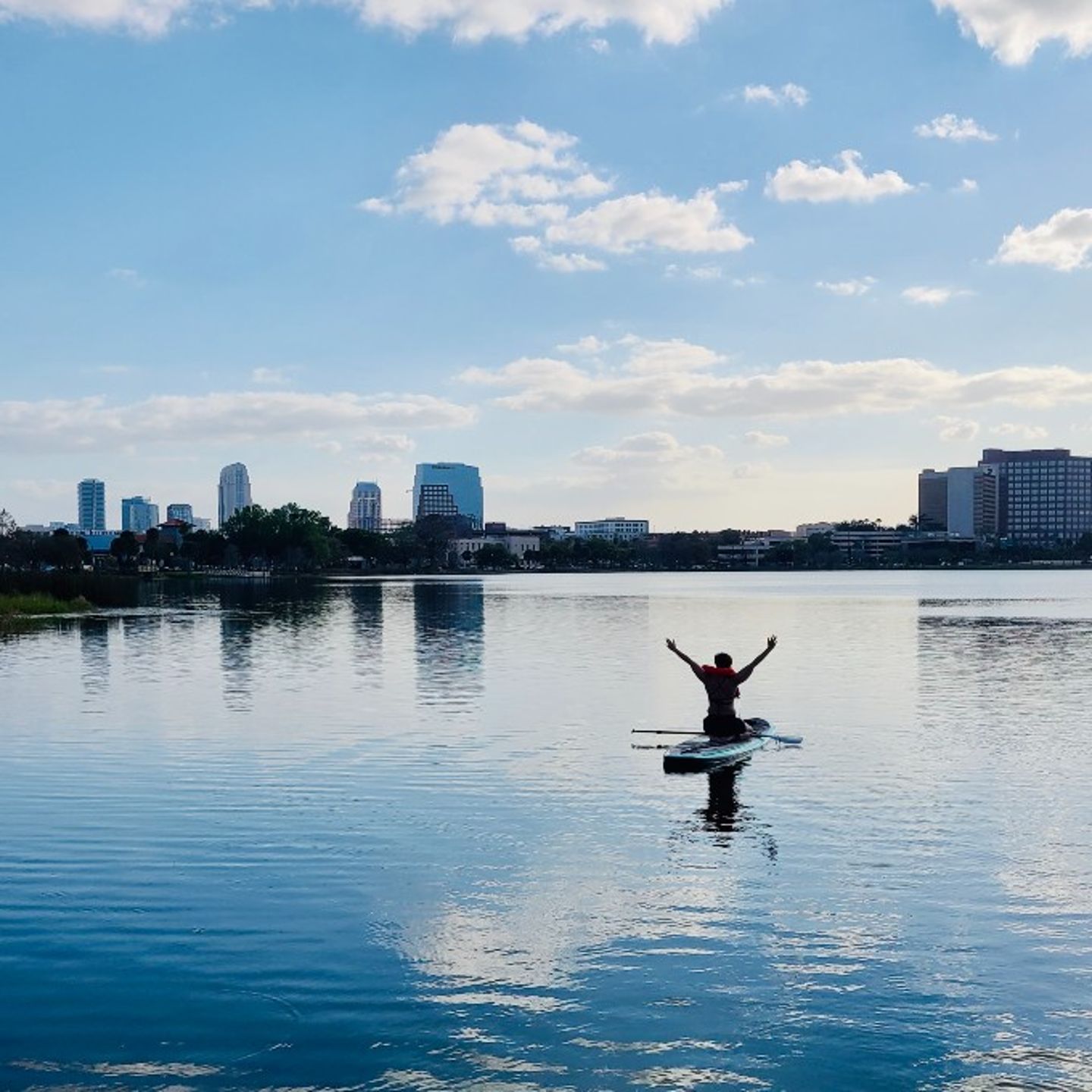 Person paddle boarding in city