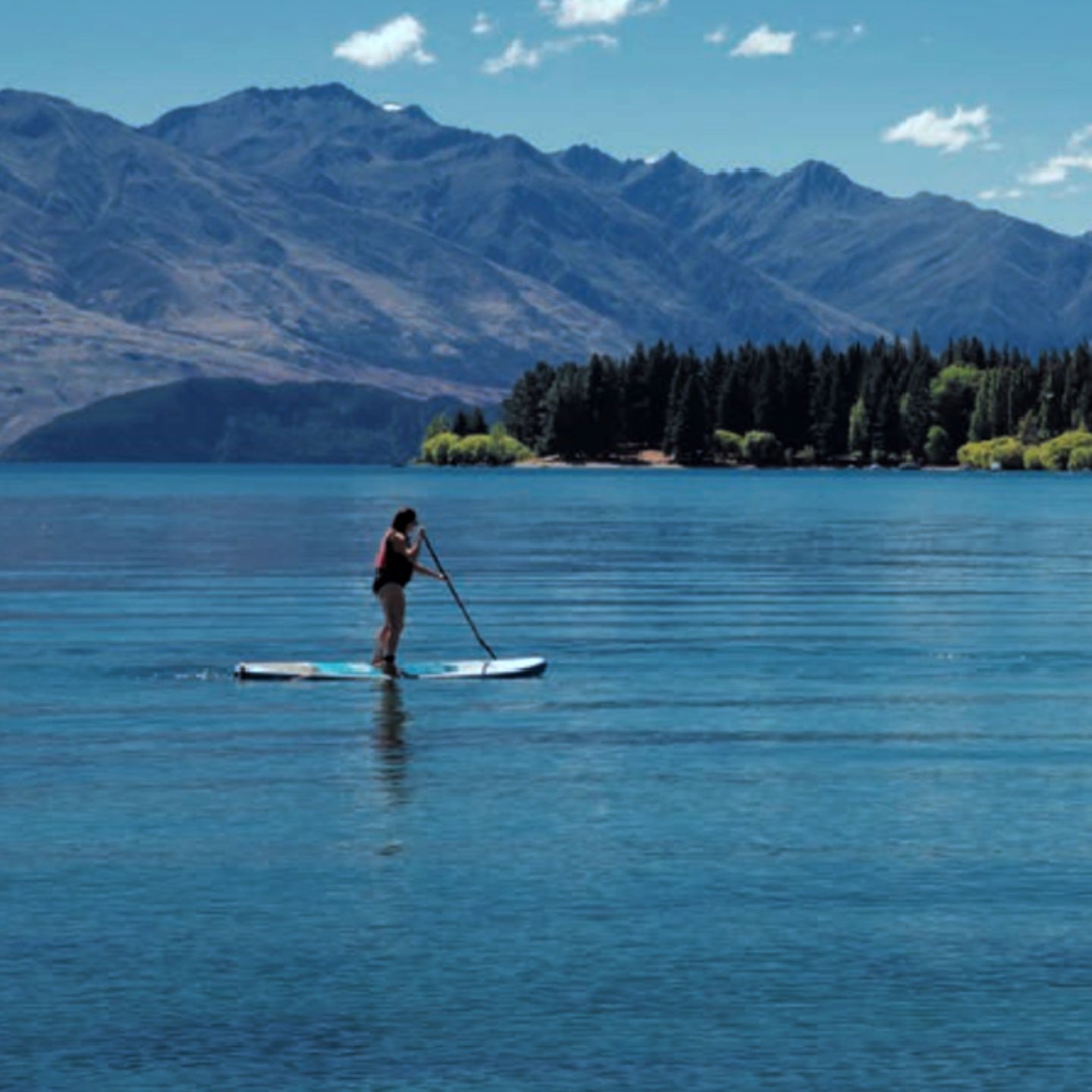 Person paddleboarding on lake