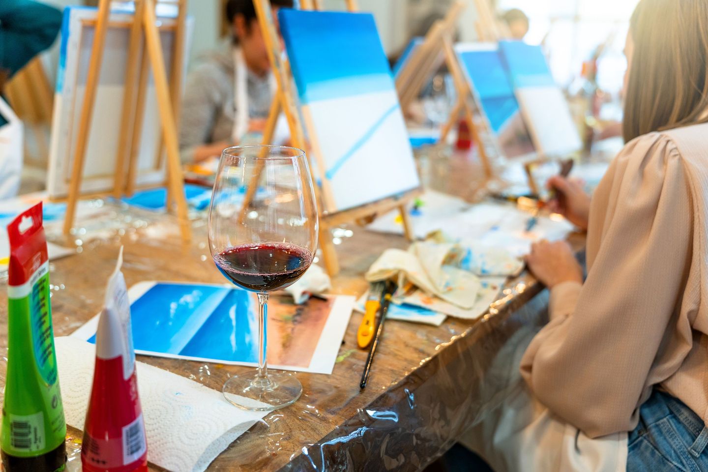 People painting with wine