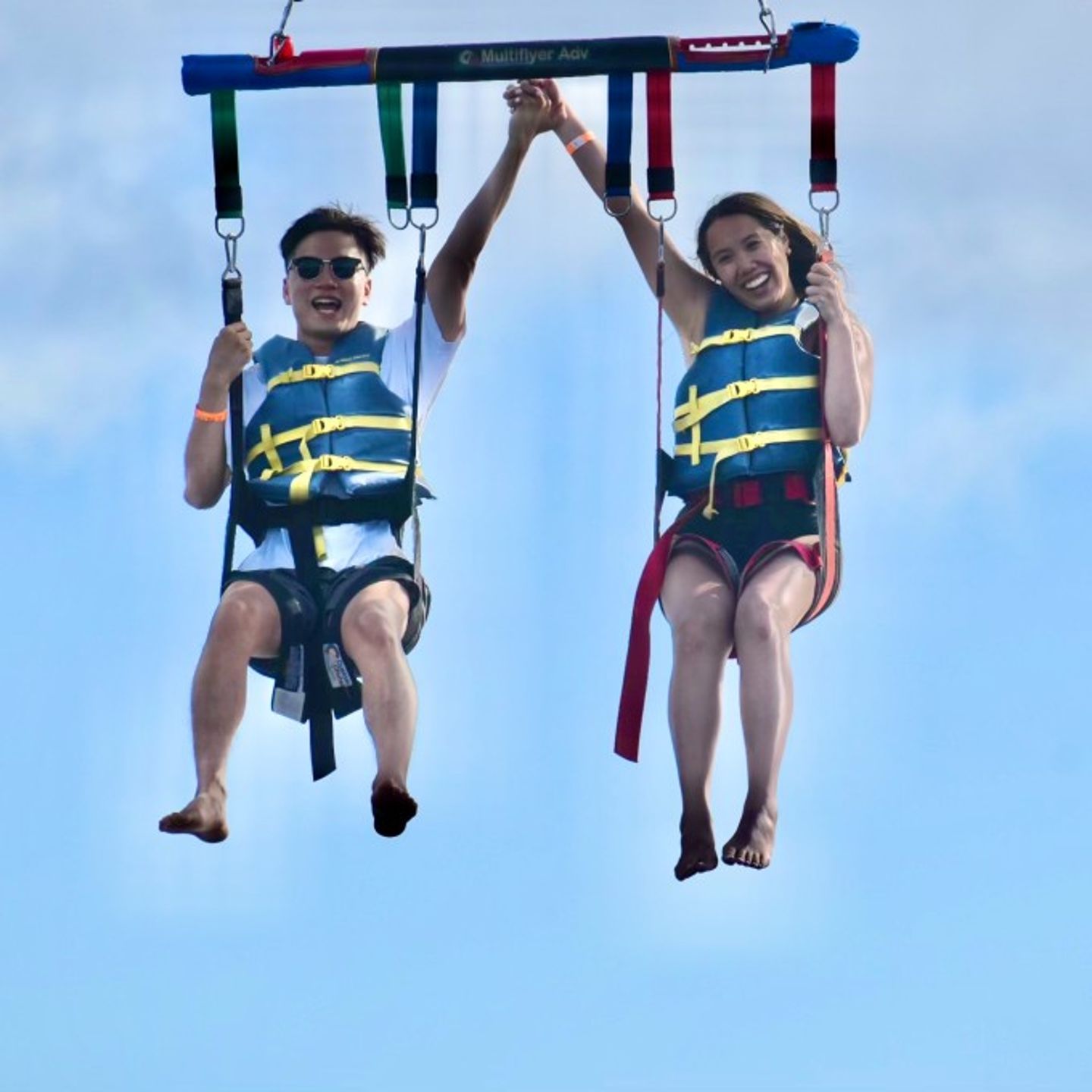 Couple holding hands in the air