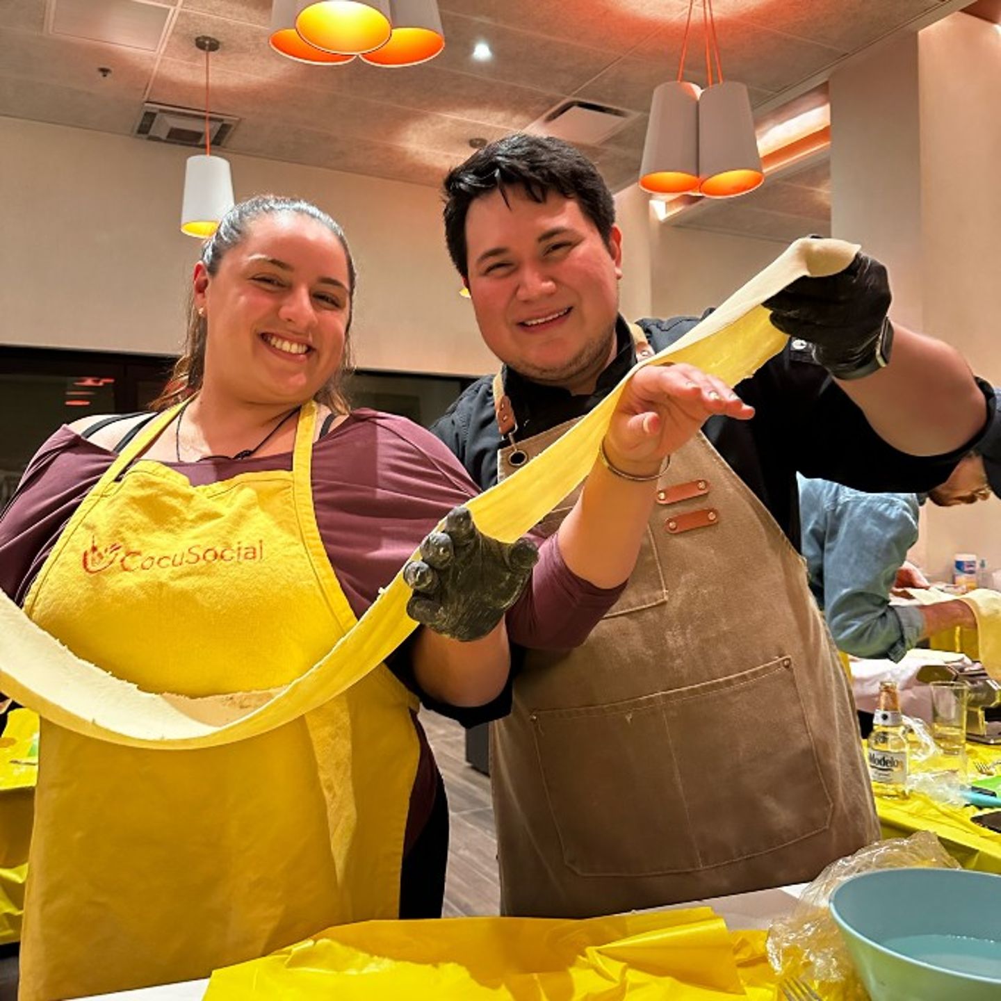 Two People Holding Pasta Sheet