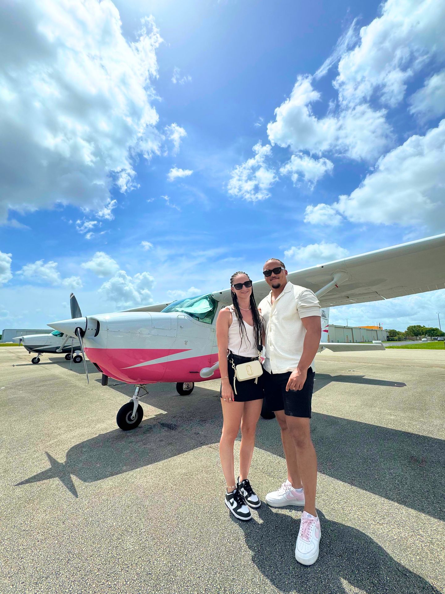 Couple next to plane