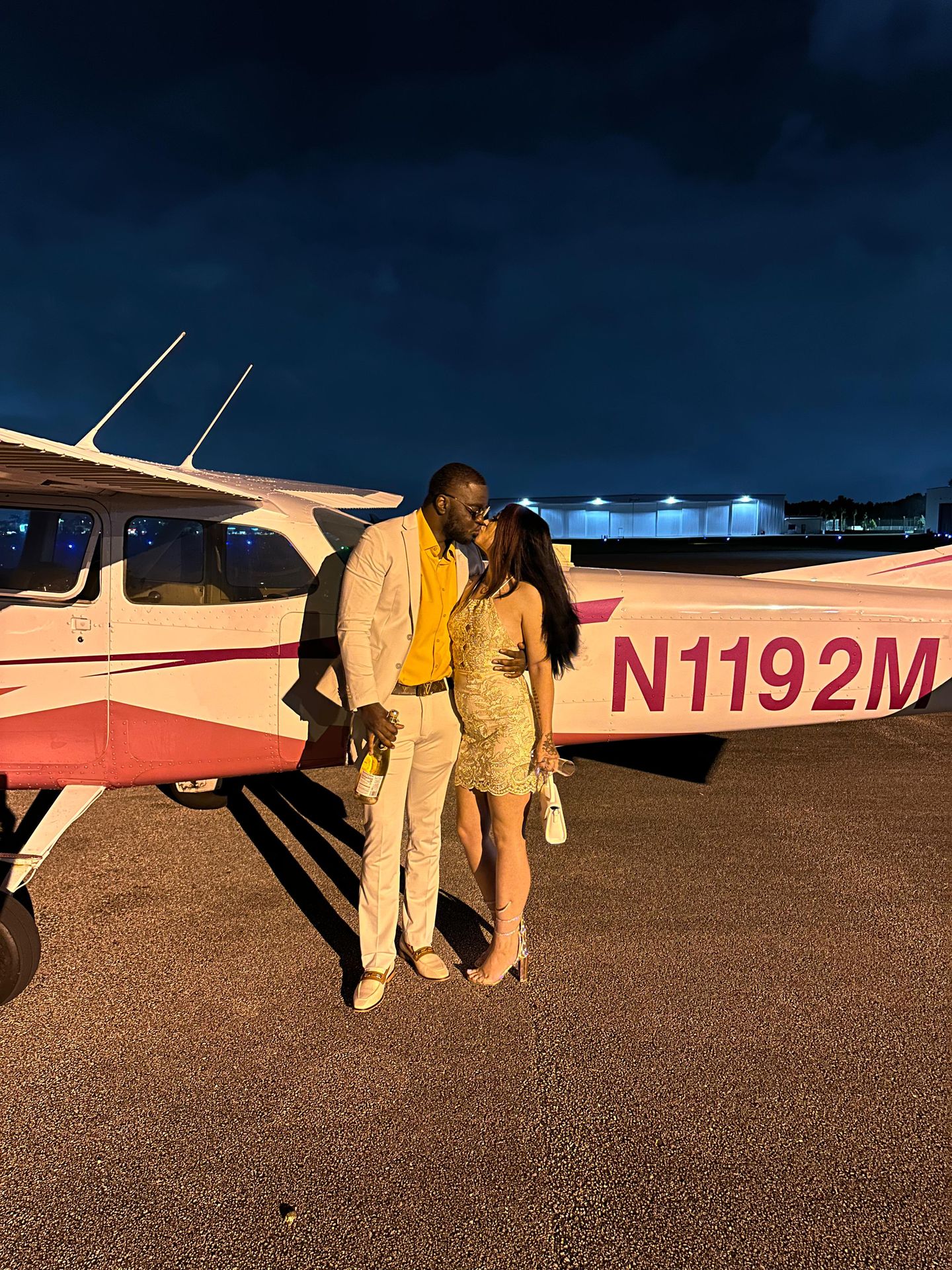 Couple in front of plane