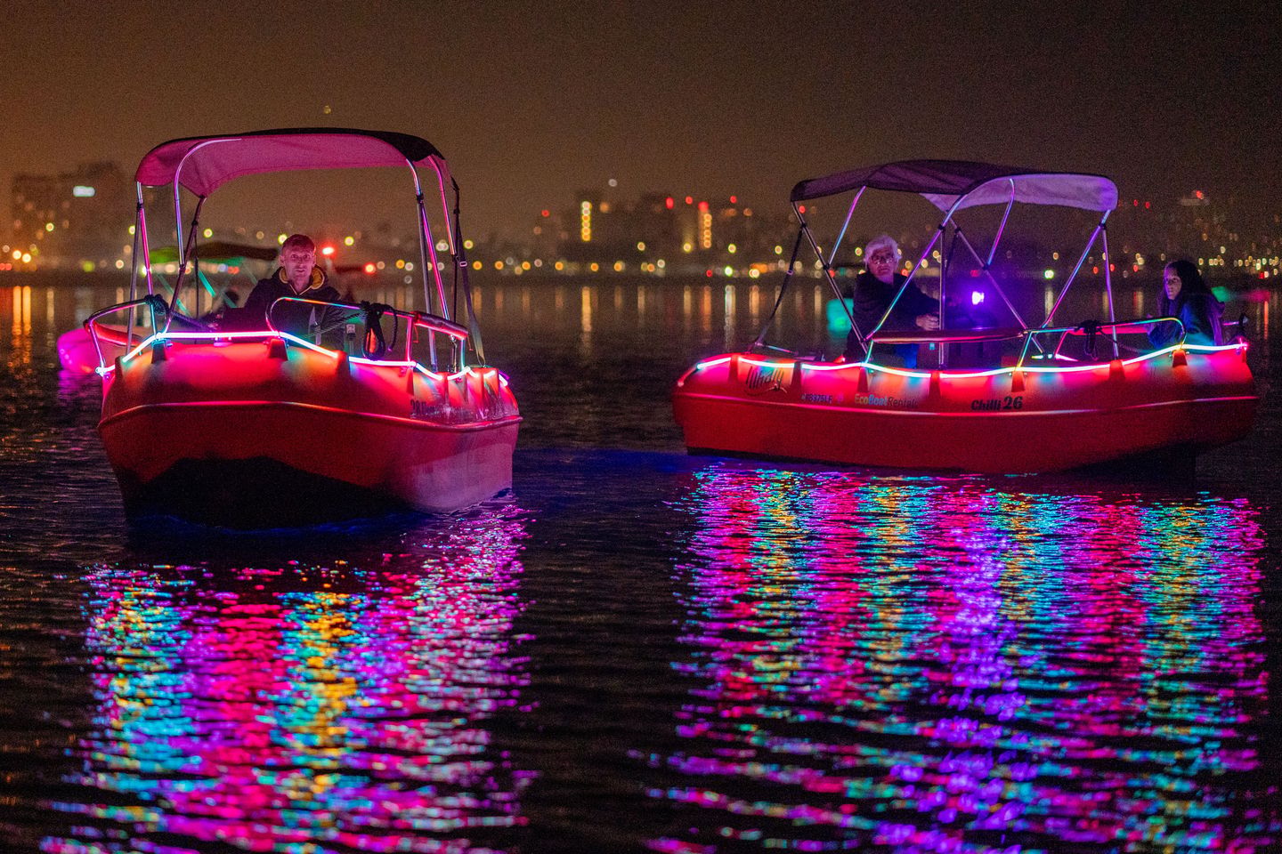Two glow boats at night