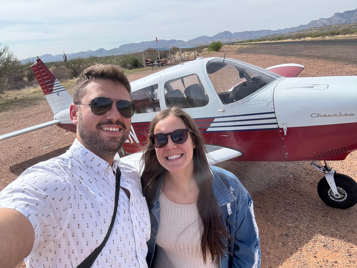 Couple in front of plane