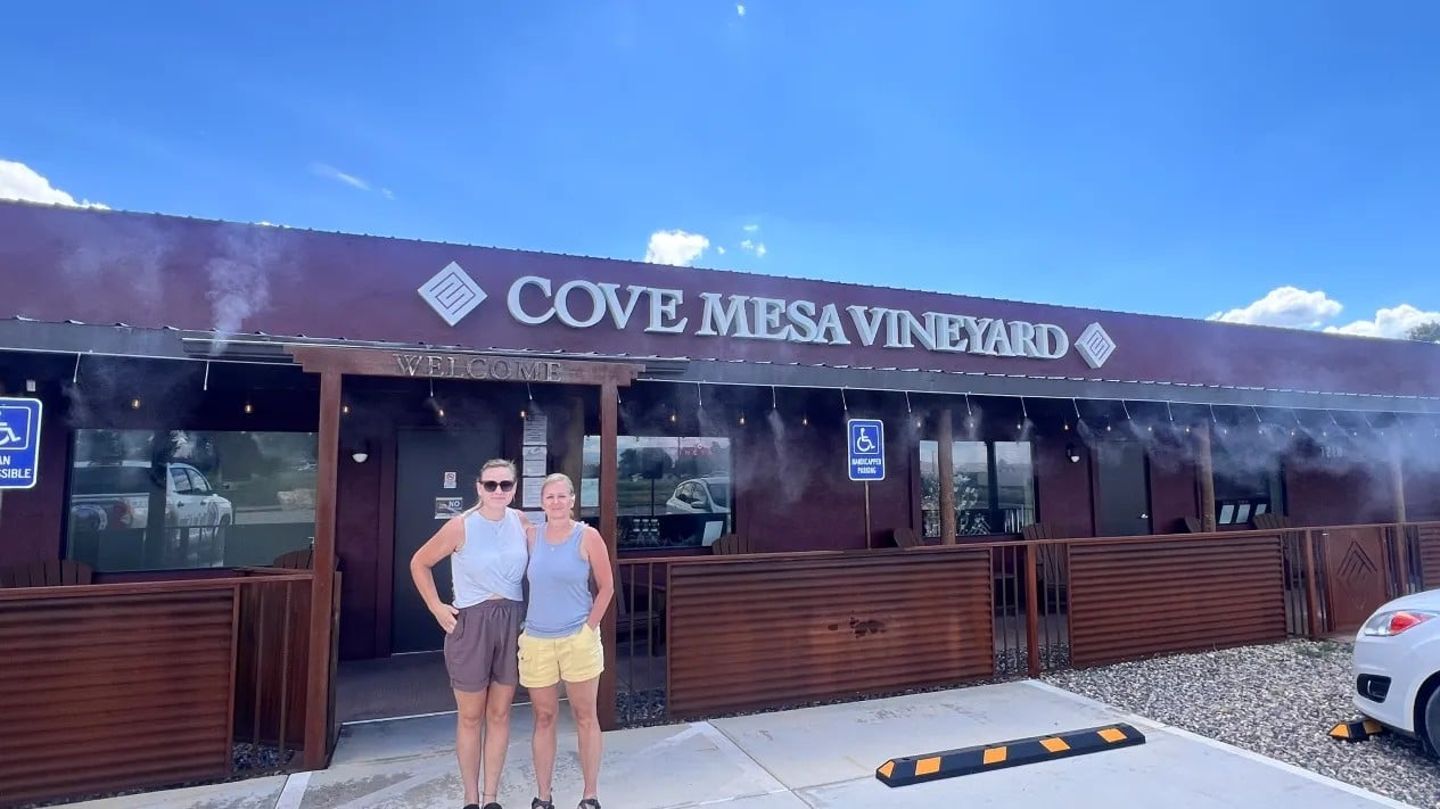 Two people outside vineyard