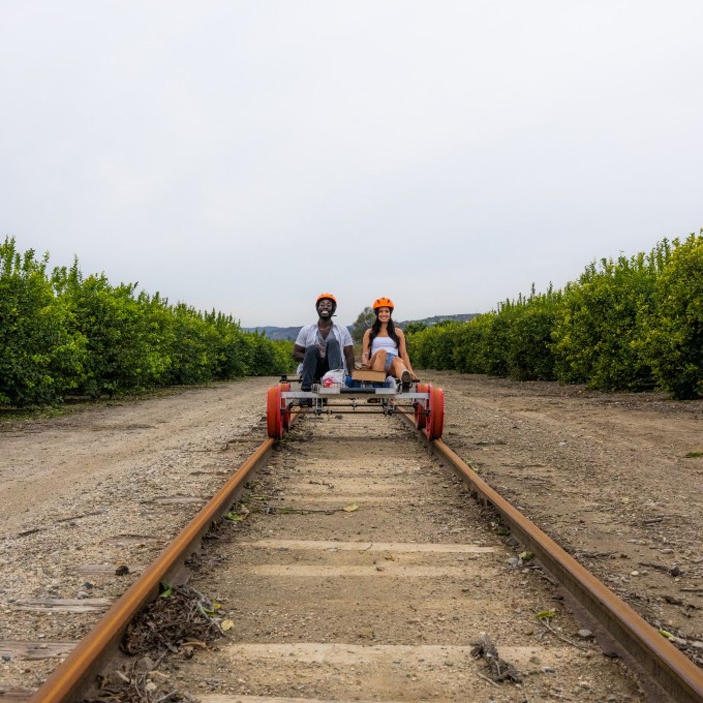 Couple pedaling down track