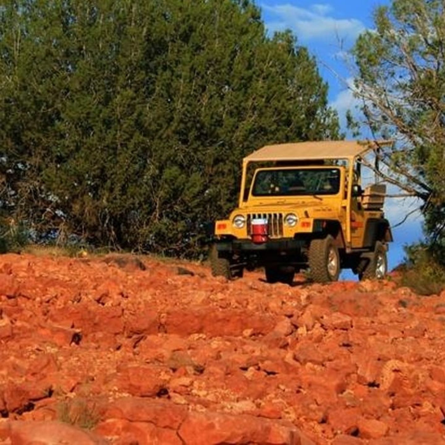 Jeep driving over rocks