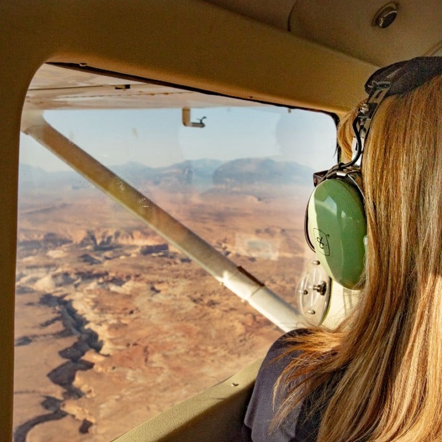 Girl Looking Out Window at Canyon