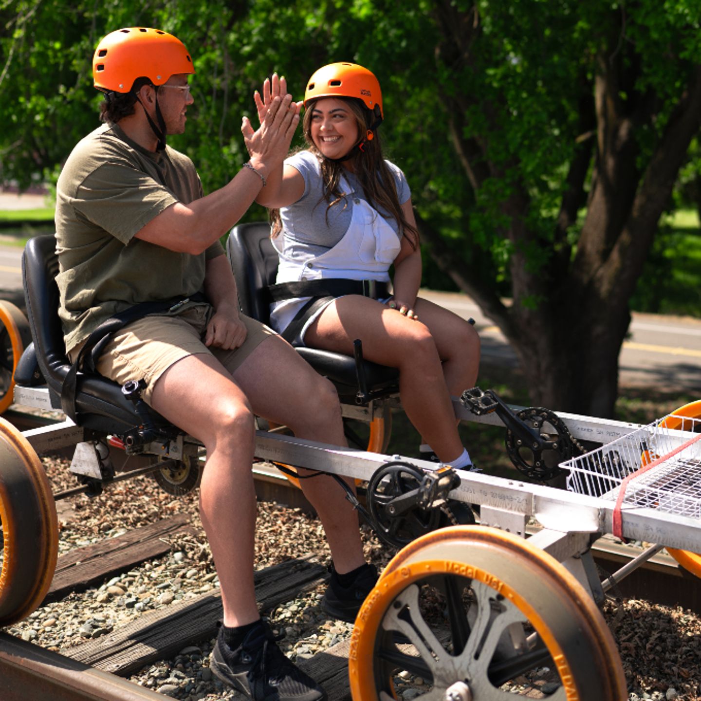 Two people high fiving on bike