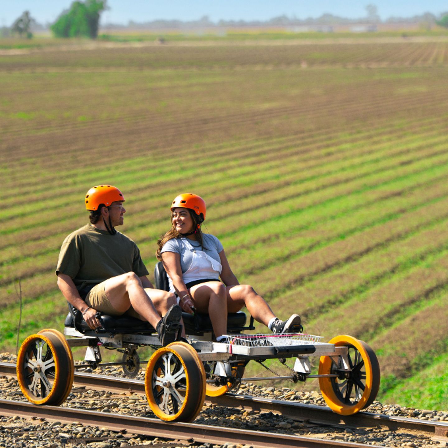 Two people on bike in field