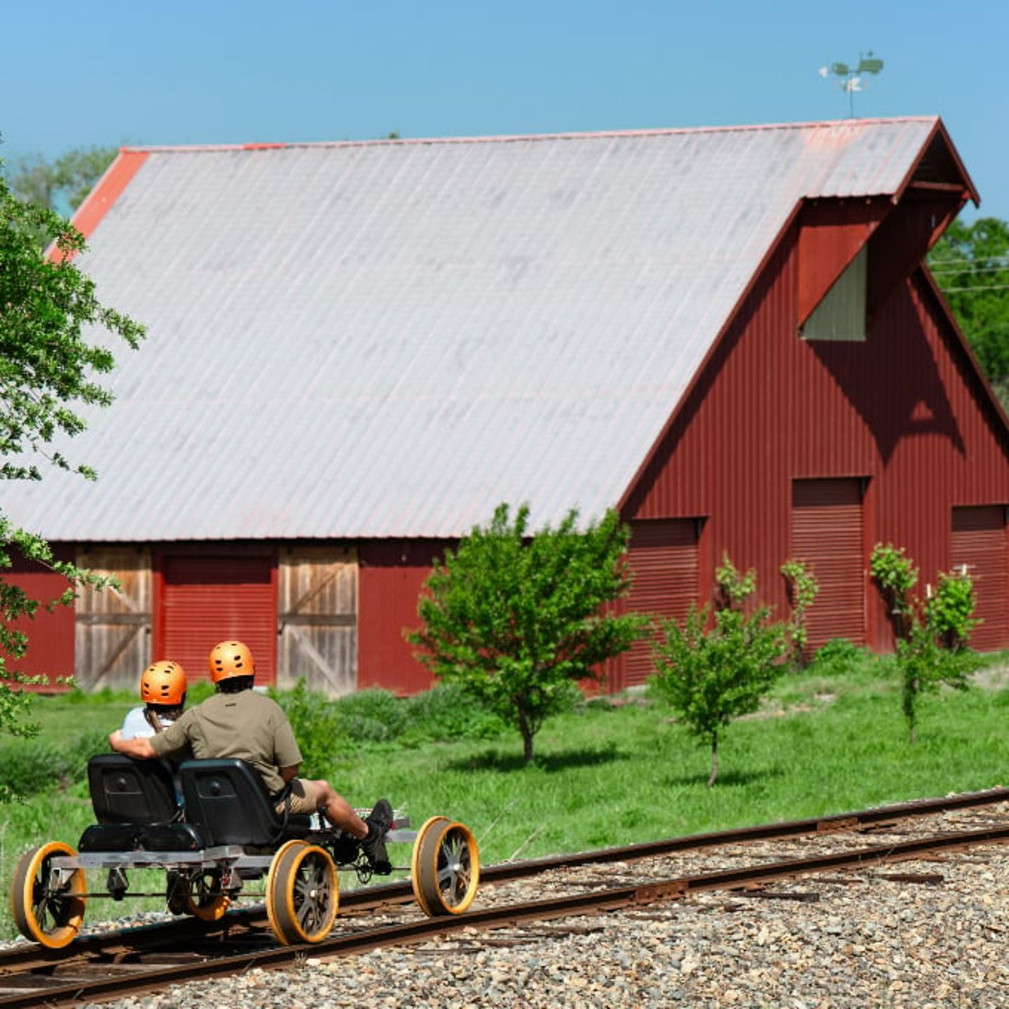 Peddling past barn
