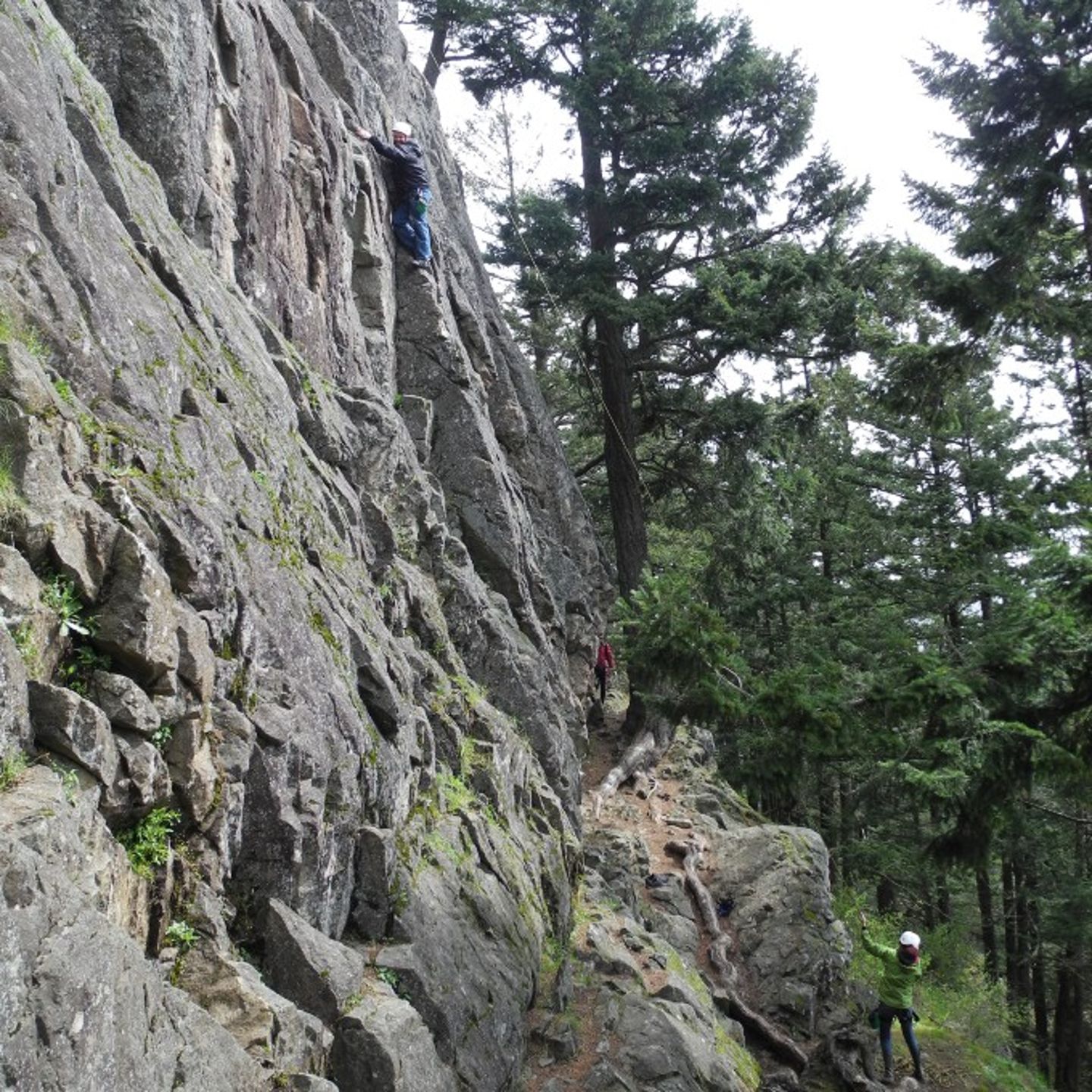 Person climbing while other is holding line