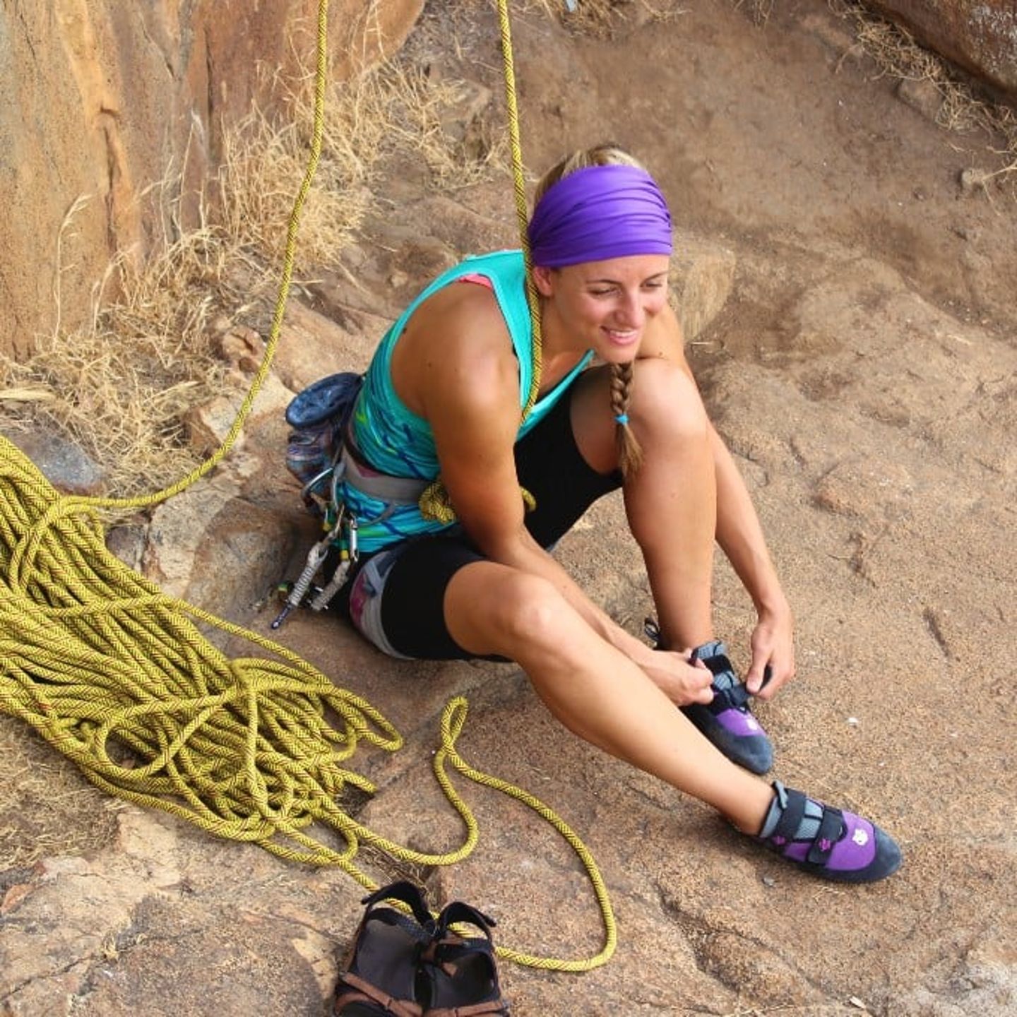 Woman sitting on ground with ropes