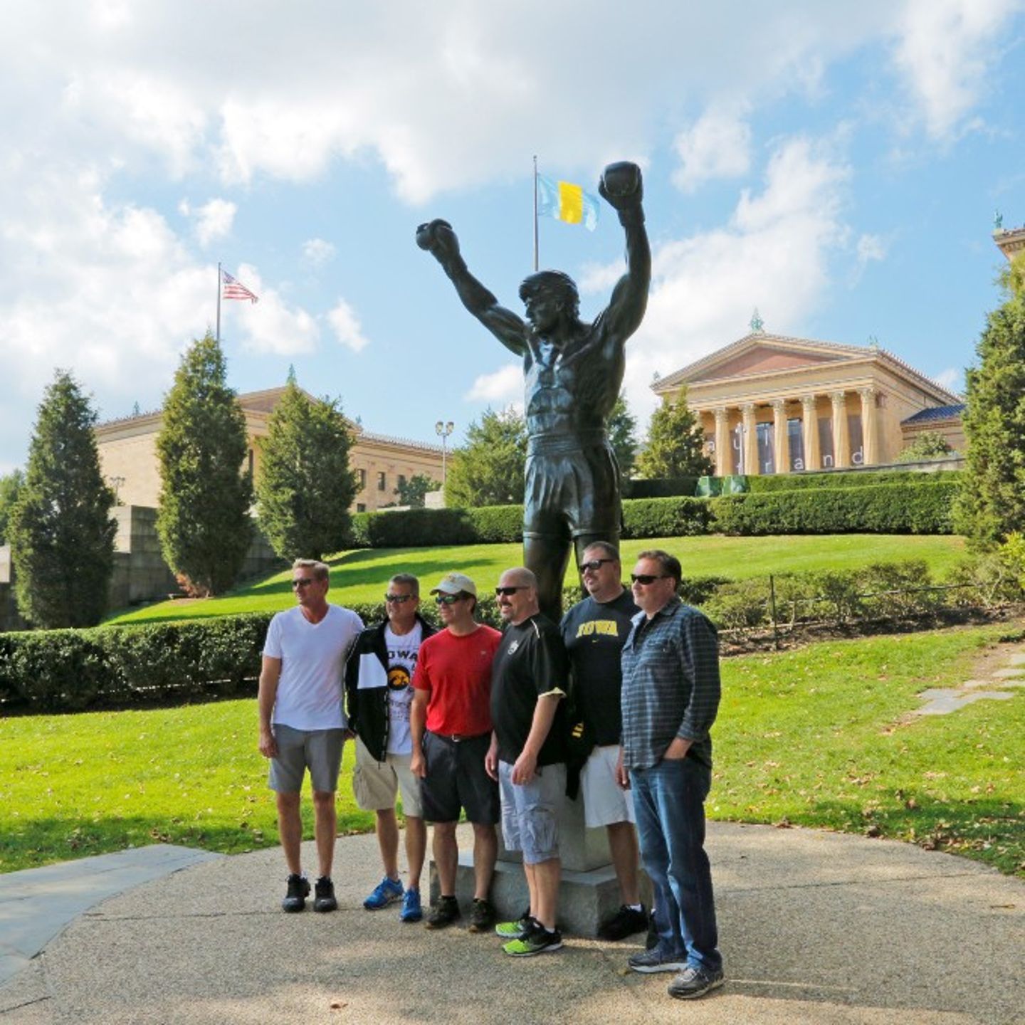 Group Posing in Front of Statue