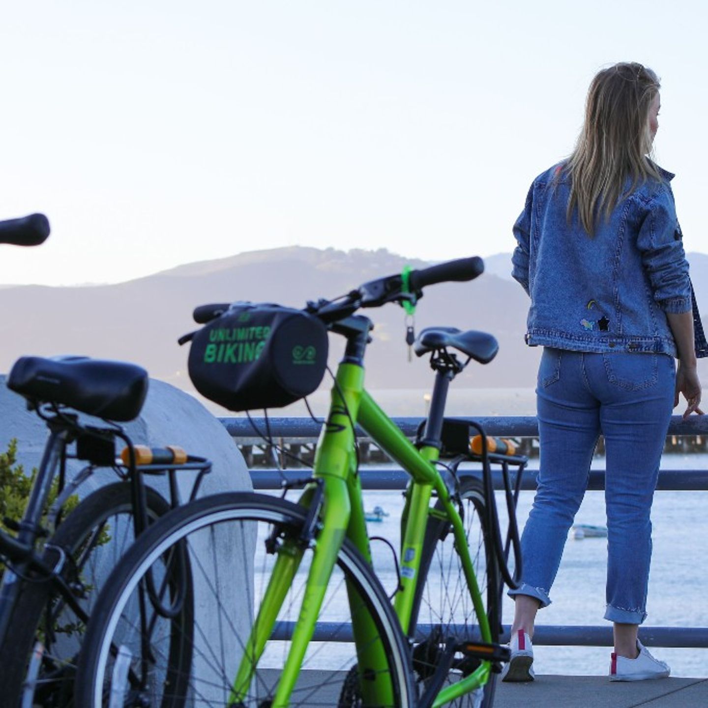 Two Bikes with Girl Looking at View