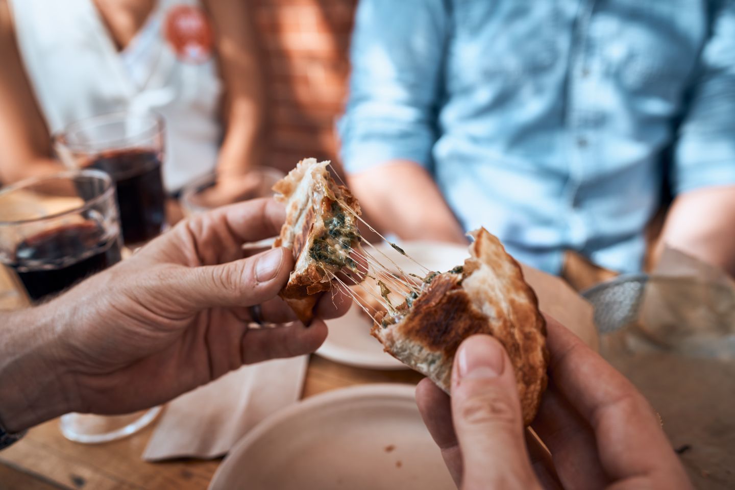 Person pulling apart empanada