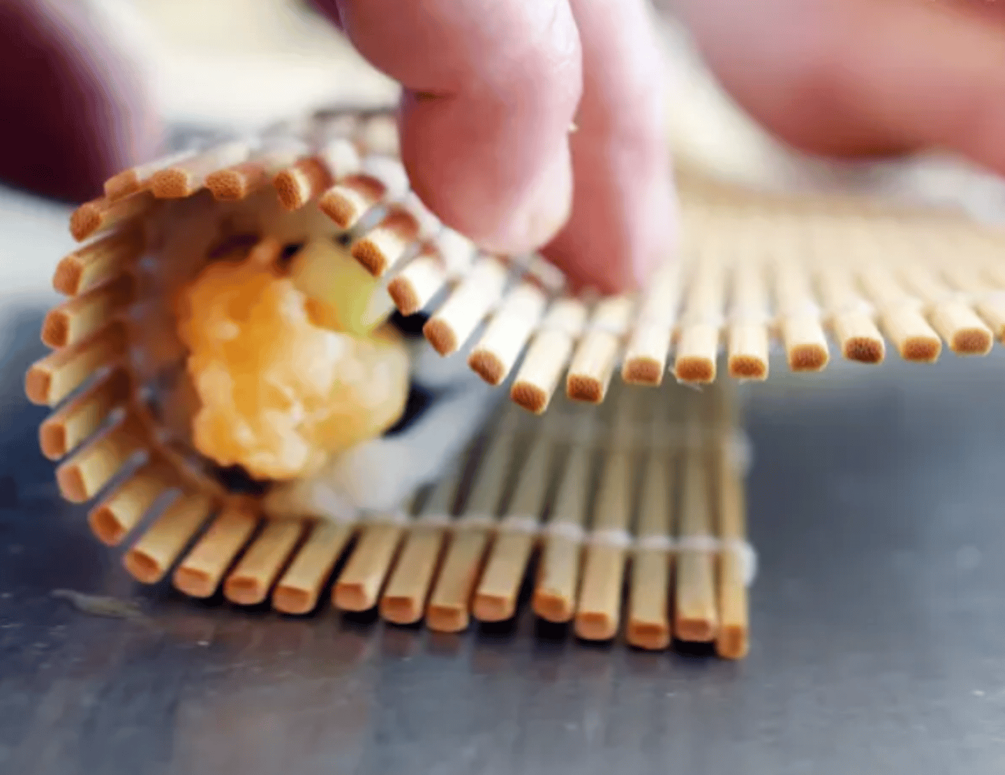 Sushi being rolled