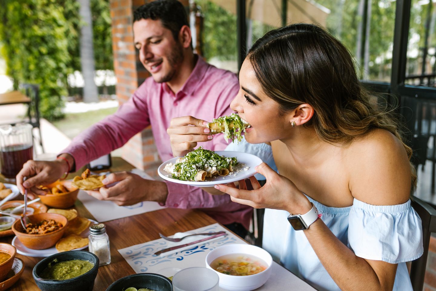 Woman eating taco