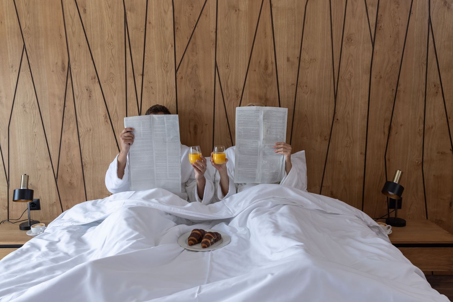 Couple in bed with drinks