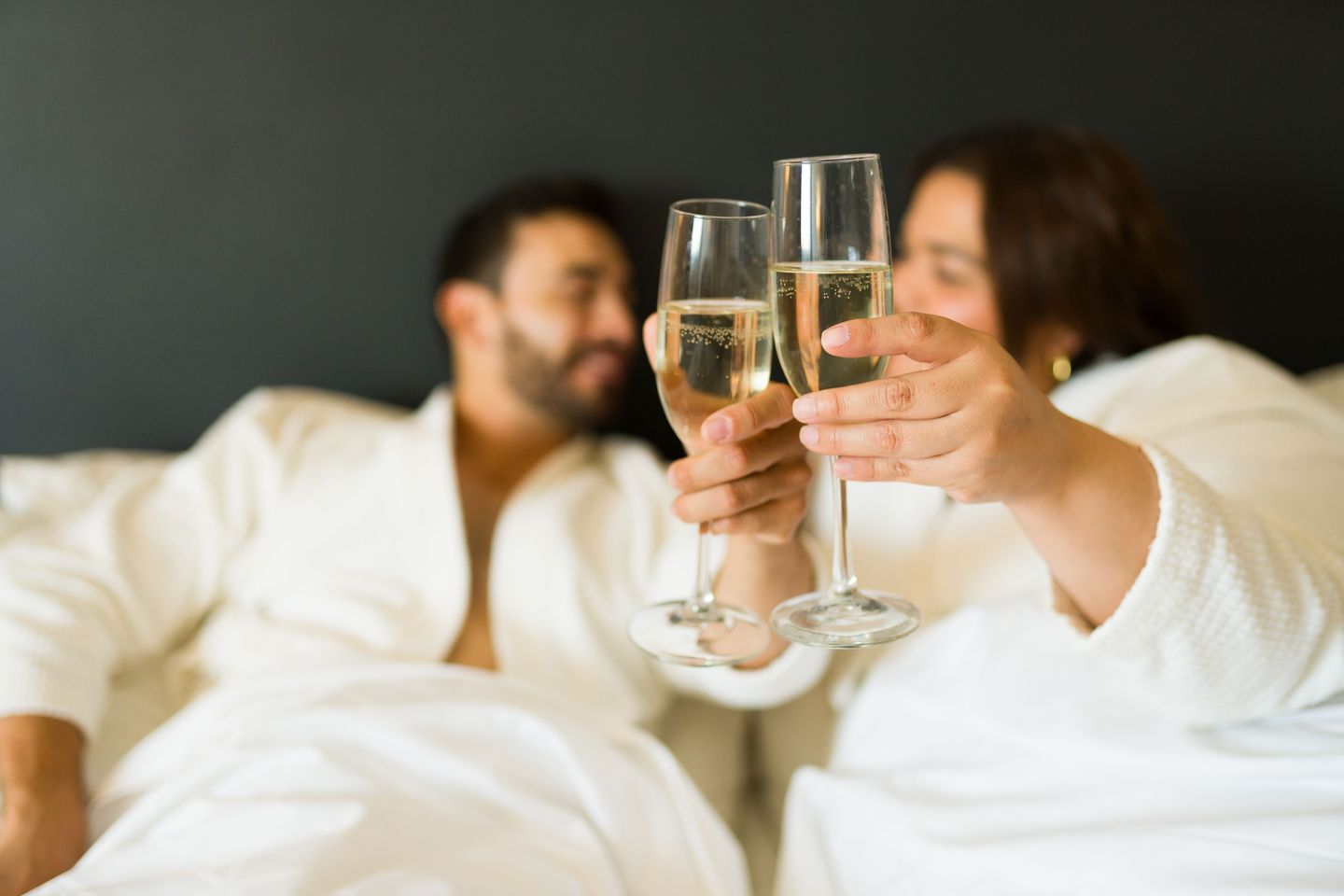 Couple enjoying champagne in bed