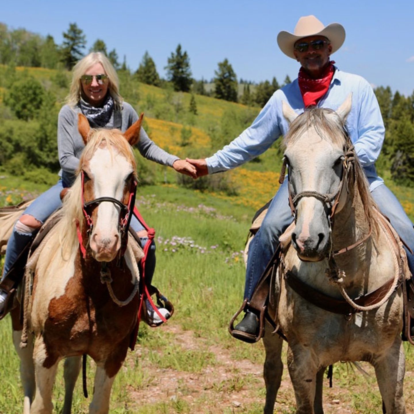 Couple Holding Hands on Horses