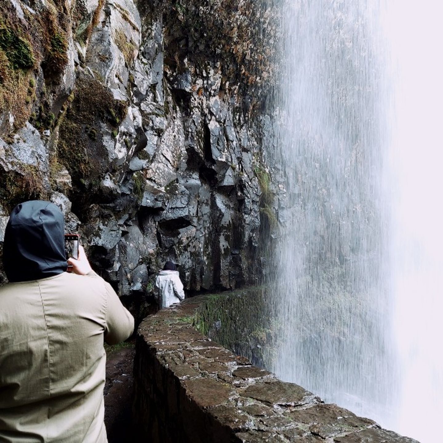 People behind waterfall