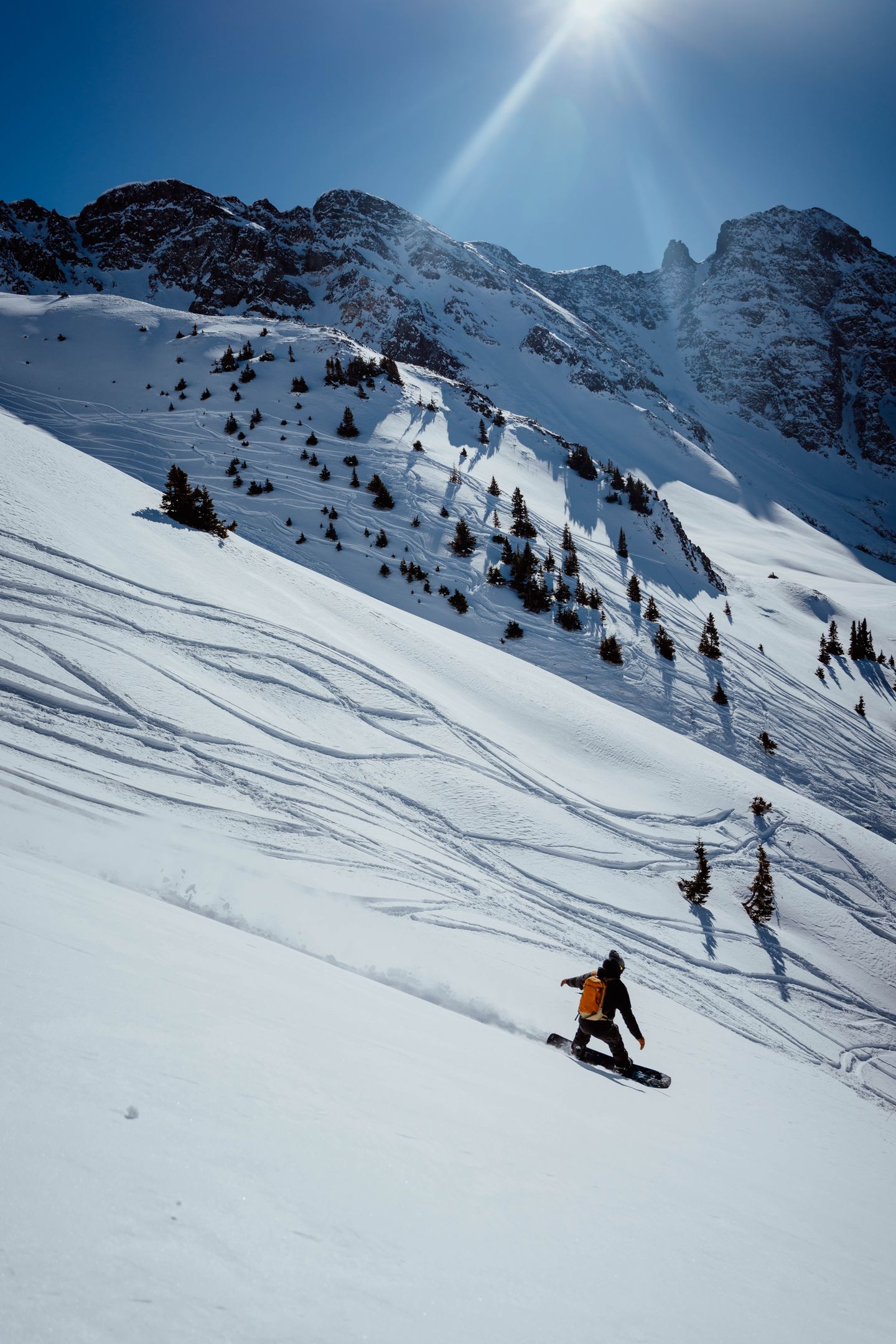 Person snowboarding down mountain