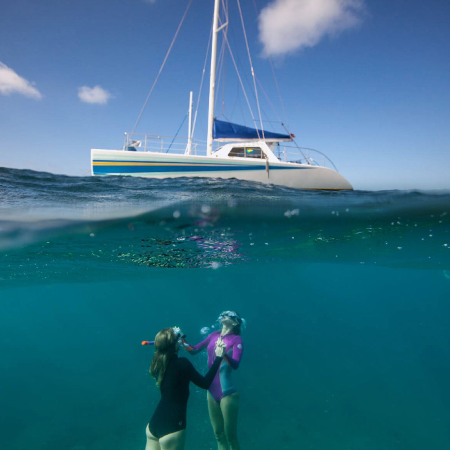 Two people snorkeling near boat