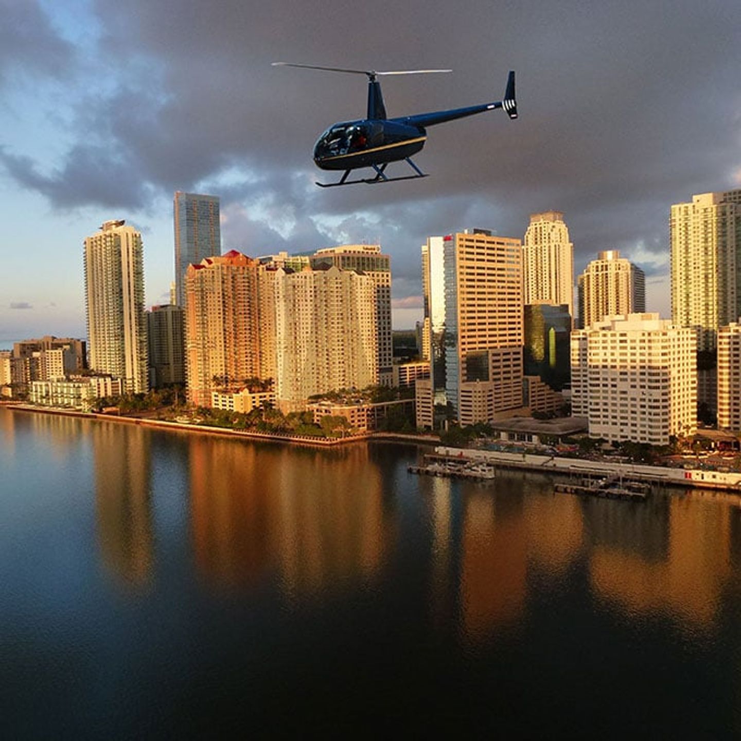 Helicopter Over Water at Sunset with Downtown Background