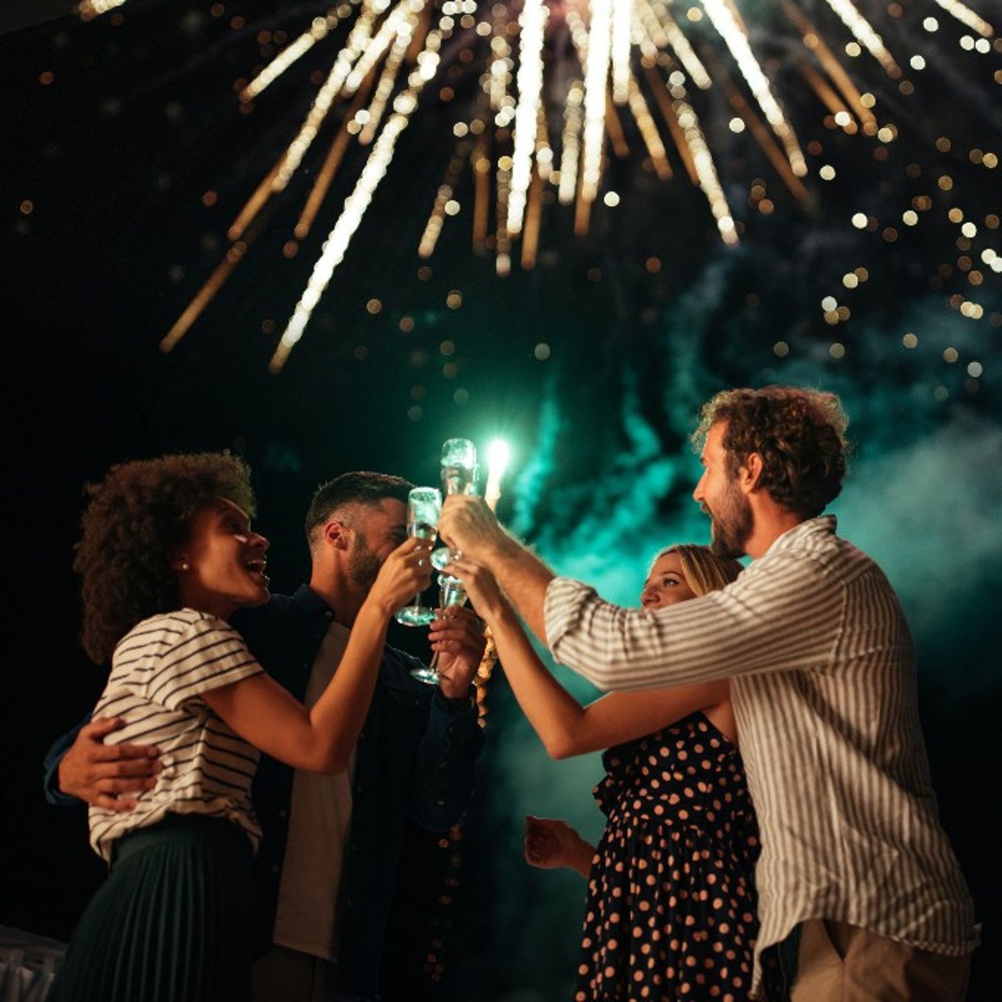 Group with drinks and fireworks