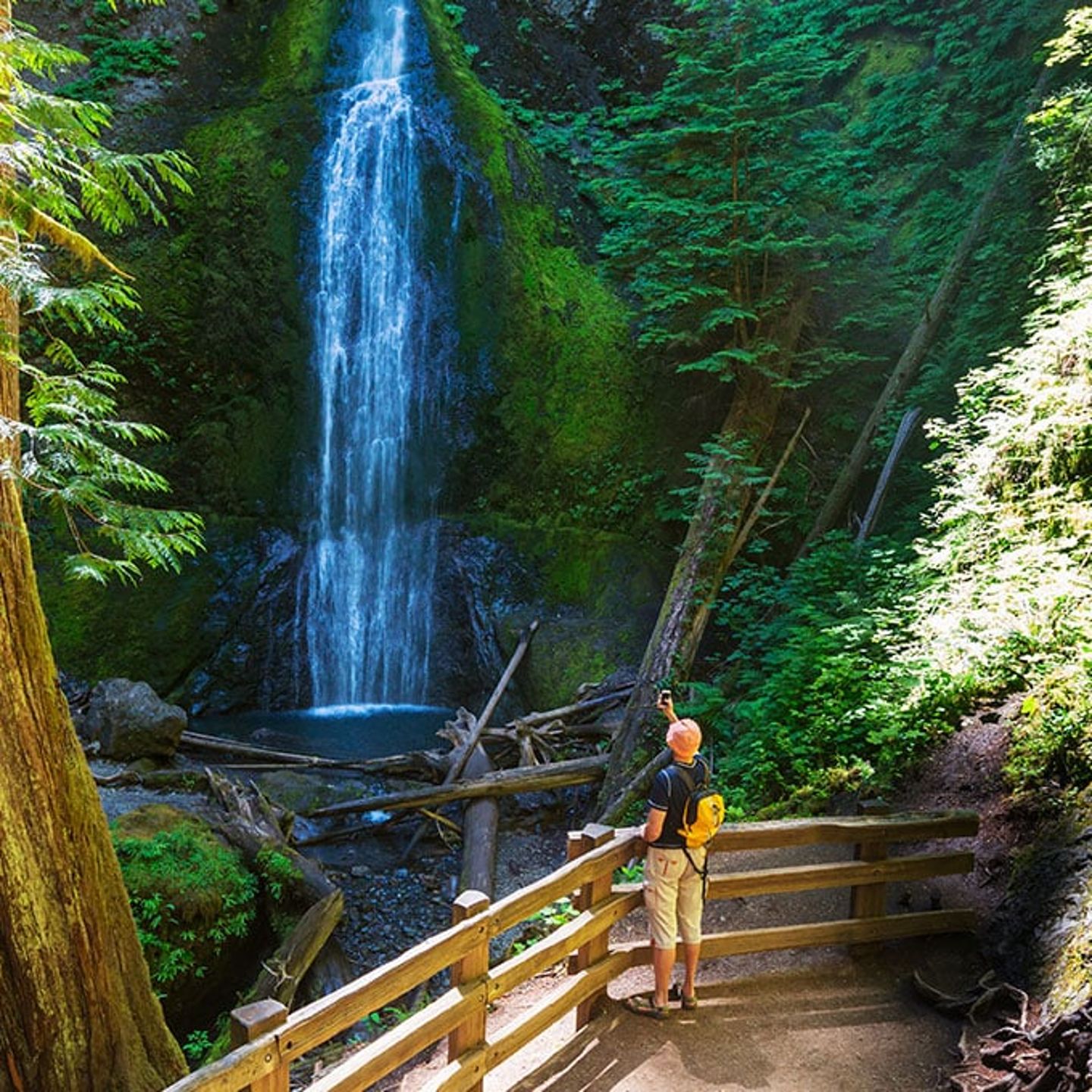 Man looking at waterfall