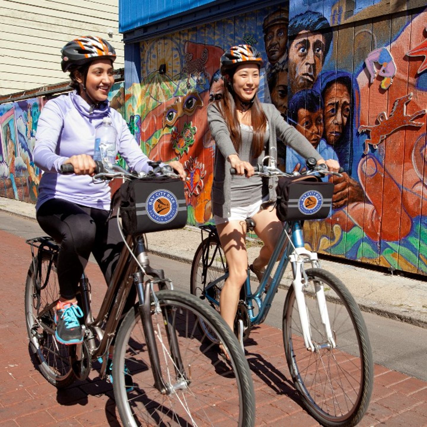 Two people passing street art