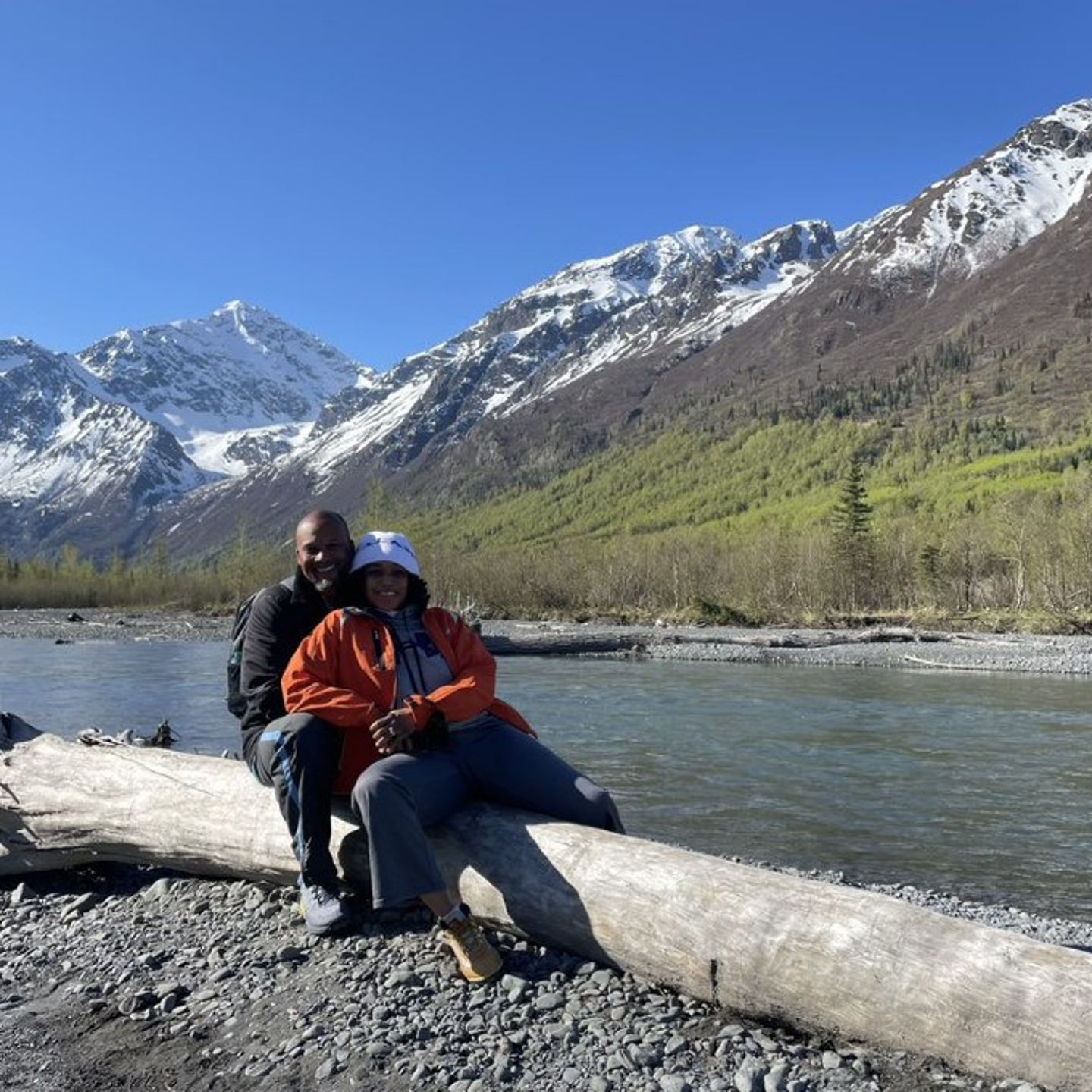 Couple posing in front on lake and mountains