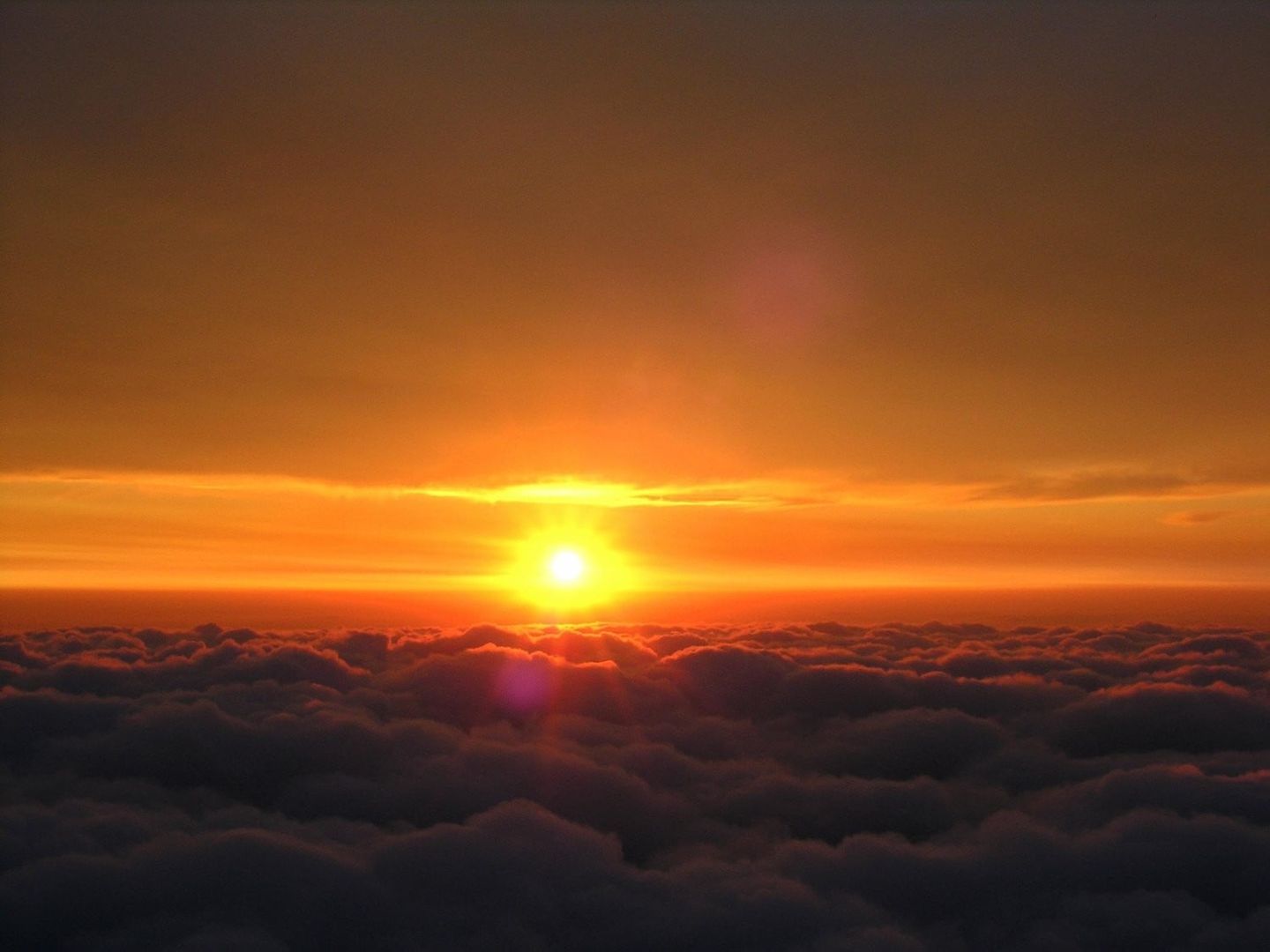 Sunset above clouds