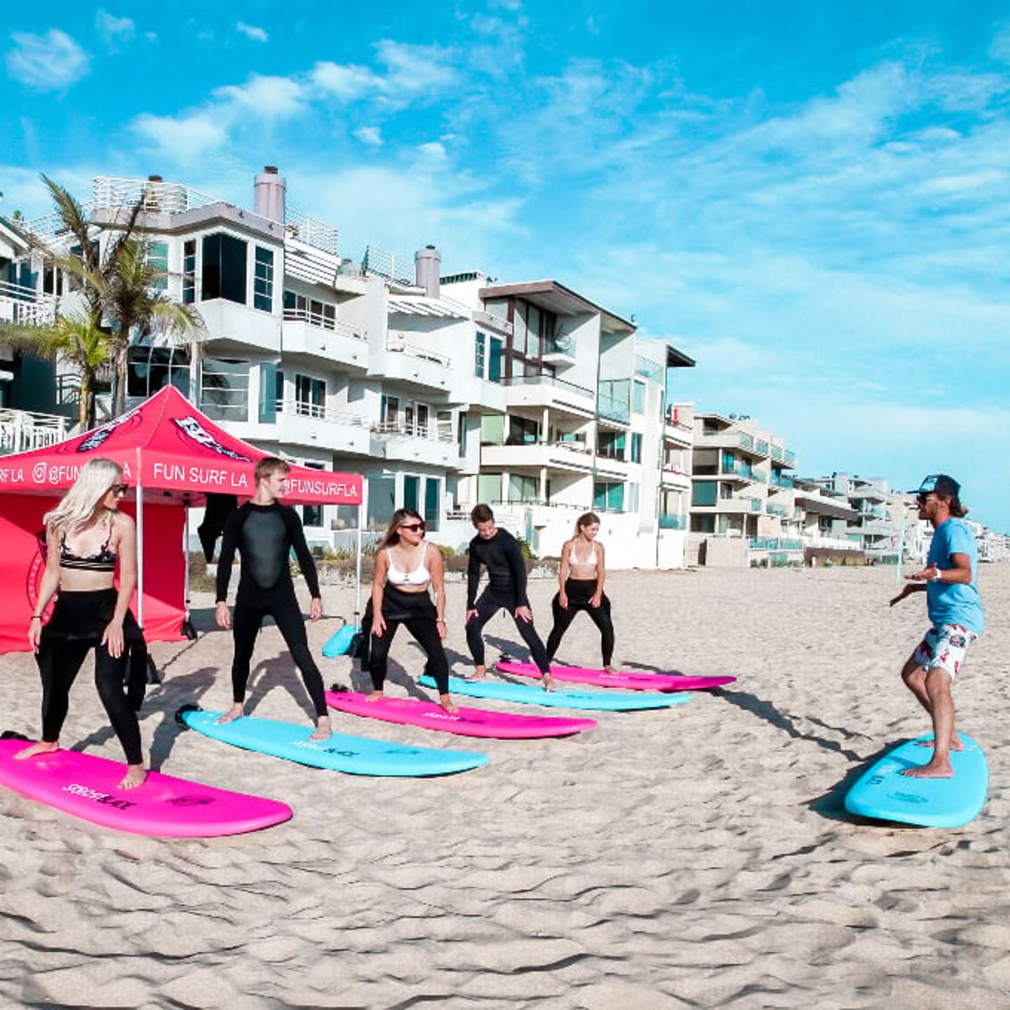 Group getting surfing lesson