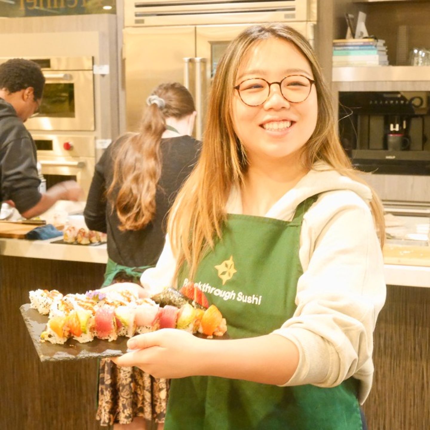 Woman holding sushi rolls