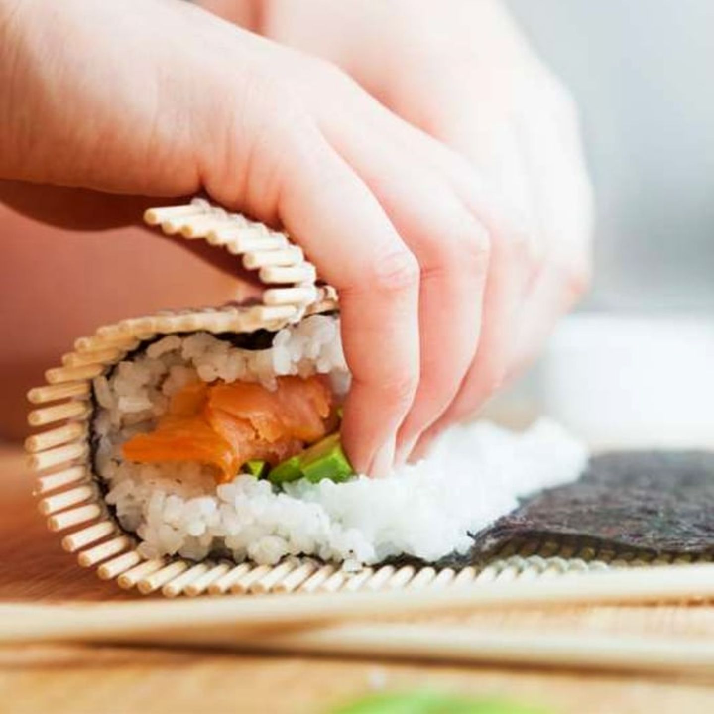 Sushi being wrapped