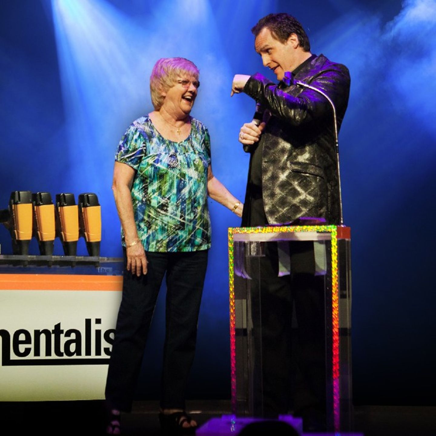 Man with older woman on stage
