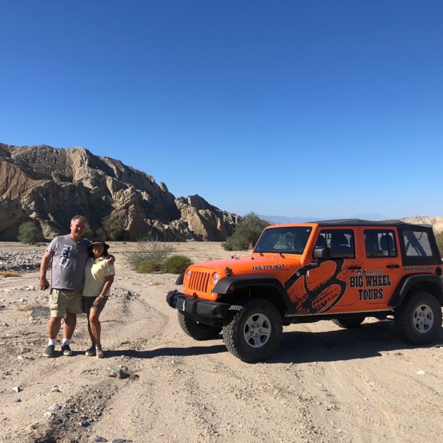 Two people posing with Jeep