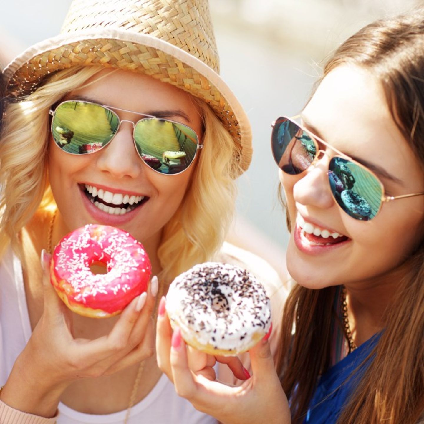 Two people eating donuts