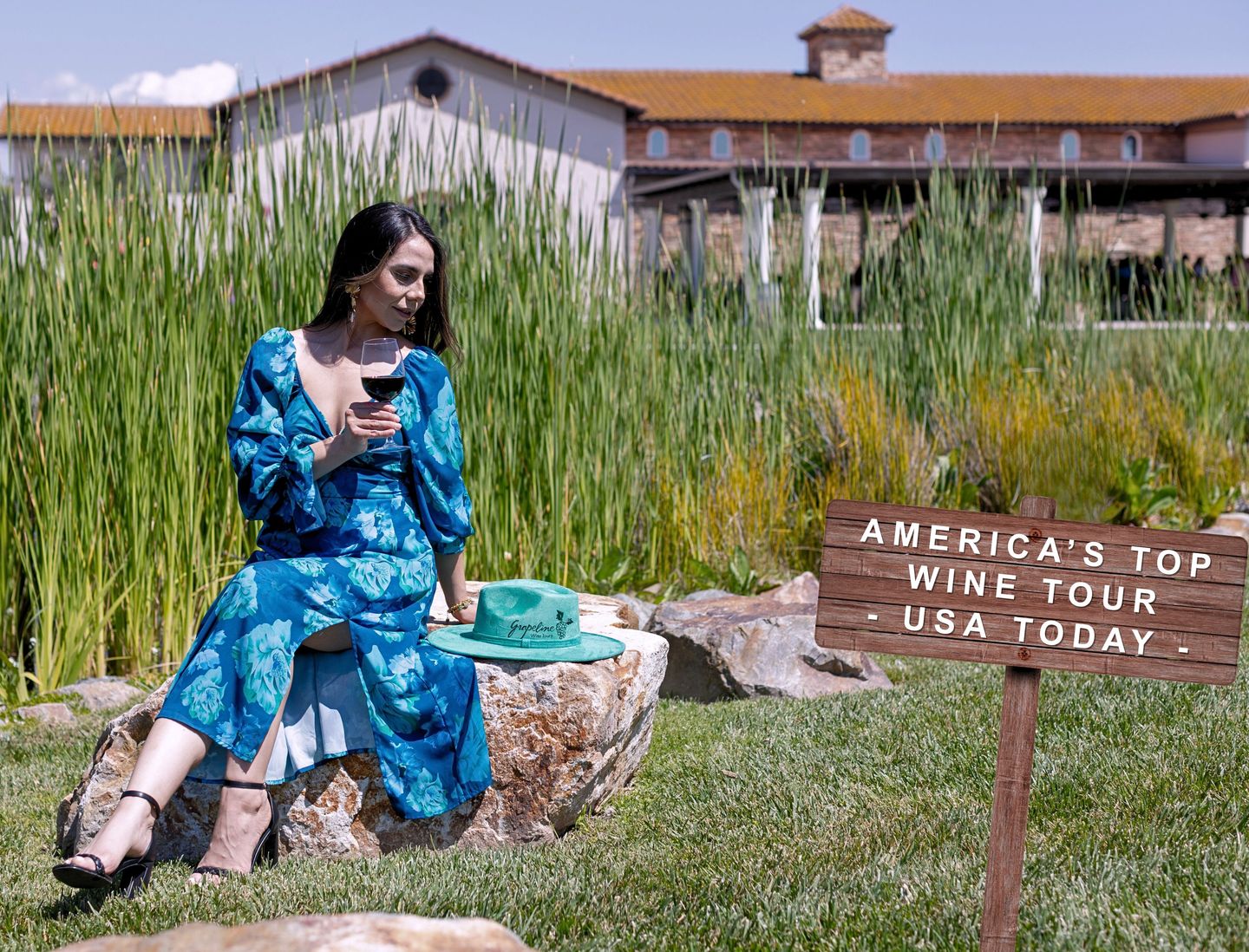 Woman holding wine on rock