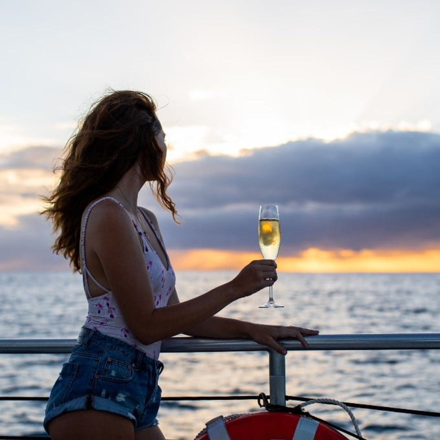 Girl on Sailbost at Sunset