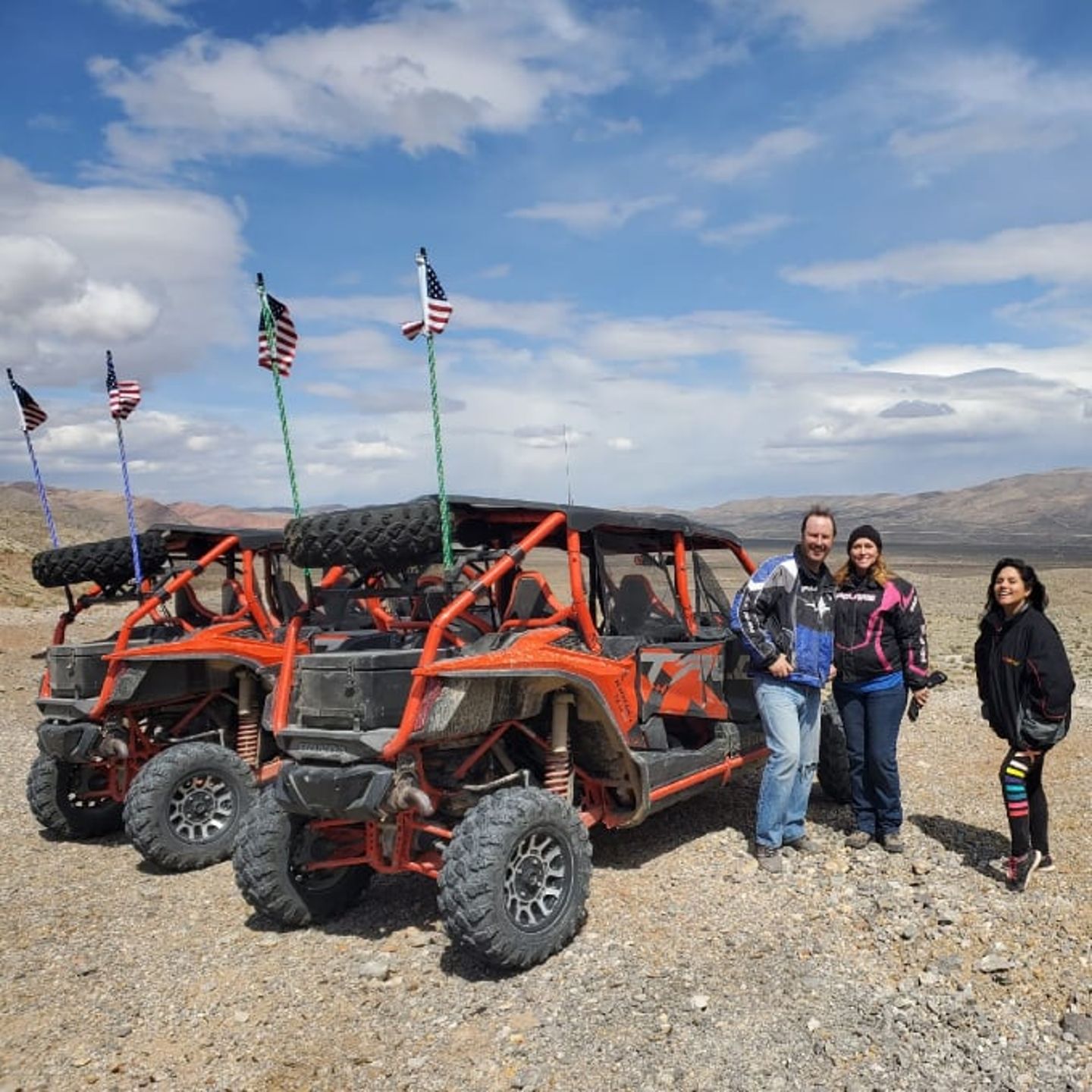People standing next to UTV's