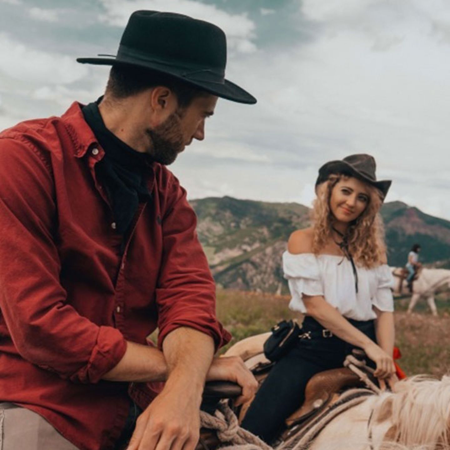 Couple Looking at Each Other on Horse