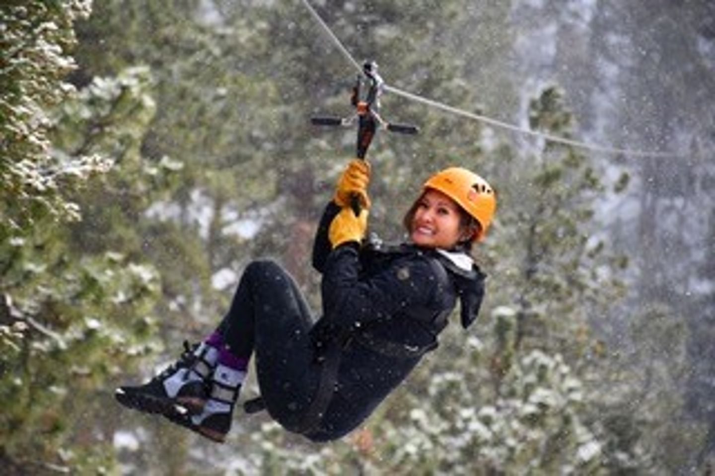 Woman on zipline in snow